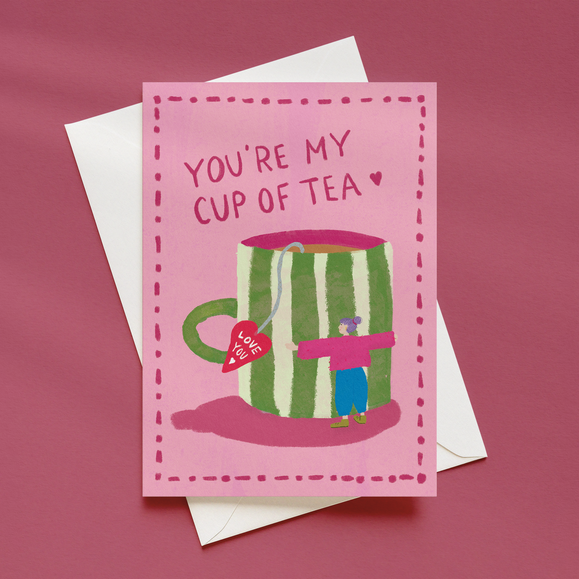 You’re My Cup of Tea illustrated greeting card mockup shown front-on with a white envelope behind on a pink background